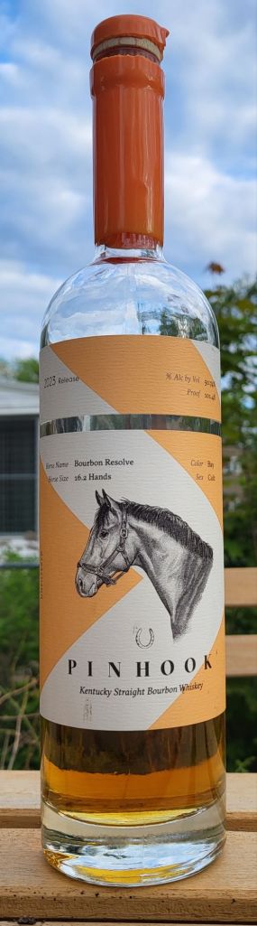 A tall, thin bourbon bottle with orange wax on the neck and the neck and head of a racehorse on the label.